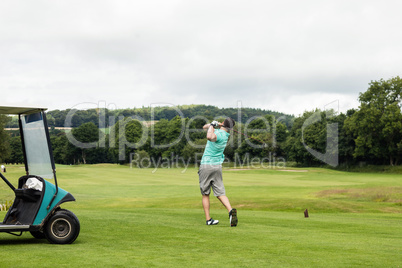 Rear view of man playing golf