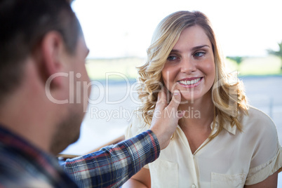 Man touching woman s face