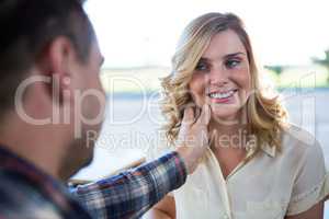 Man touching woman s face