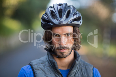 Close-up of serious male biker in countryside