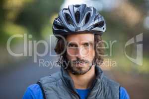 Close-up of serious male biker in countryside