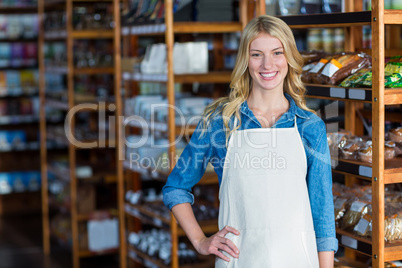 Portrait of smiling female staff standing with hand on hip Portrait of smiling female staff standing with hand on hip