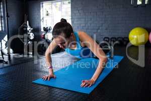 Sporty young woman doing push-ups