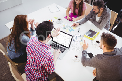 High angle view of partners discussing in meeting room at creative office