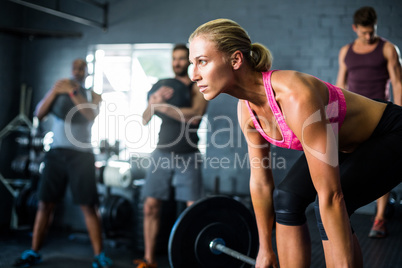 Female athlete lifting barbell