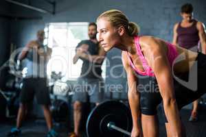 Female athlete lifting barbell