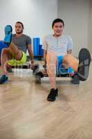 Two men doing aerobic exercise on stepper