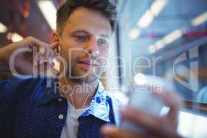 Handsome man listening music on mobile phone