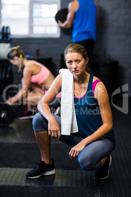 Full length portrait of serious woman in gym