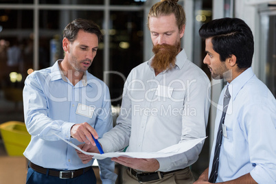 Businessmen discussing over blueprint