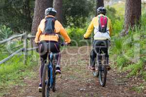 Biker couple cycling in countryside