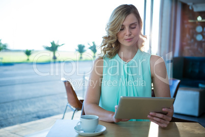 Woman using a digital tablet in the coffee shop