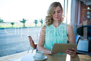 Woman using a digital tablet in the coffee shop