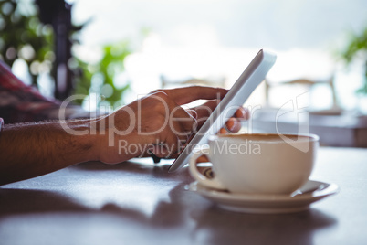 Hands of man using digital tablet