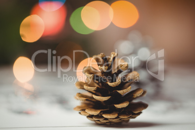 Close-up of pine cone on wooden table