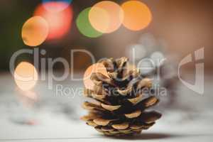 Close-up of pine cone on wooden table