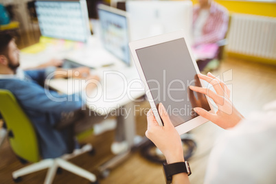 Businesswoman using tablet computer at creative office