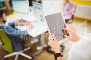 Businesswoman using tablet computer at creative office