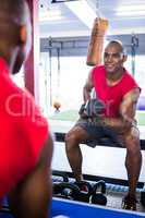 Man smiling while exercising with dumbbells