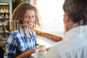 Smiling couple having coffee