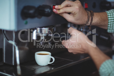 Waiter making cup of coffee