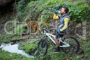 Male mountain biker drinking water