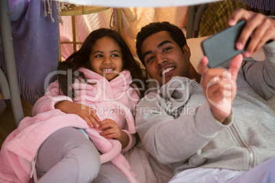 Father and daughter taking a selfie