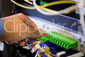 Technician plugging patch cable in a rack mounted server