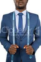 Businessman holding a measuring tape around is neck