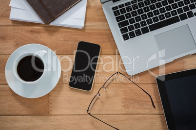 Laptop, digital tablet, mobile phone and organizer on desk