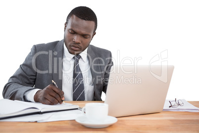 Concentrated businessman working at office desk