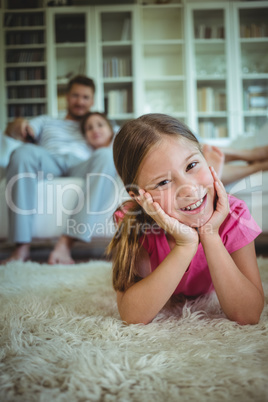 Happy girl lying on the floor