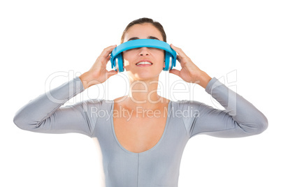 Smiling woman in exercise outfit using virtual video glasses