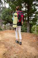 Female hiker walking in forest with backpack