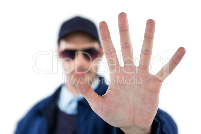 Confident security officer making stop gesture