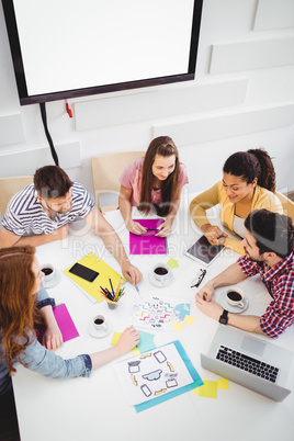 High angle view of colleagues discussing in meeting at creative office