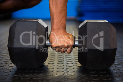 Man holding dumbbell in gym