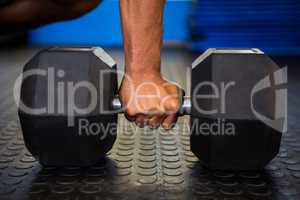 Man holding dumbbell in gym