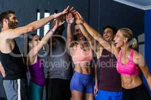 Athletes stacking hands in fitness studio