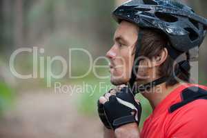 Close-up of male mountain biker wearing bicycle helmet