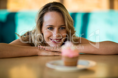 Woman looking at cupcake on plate