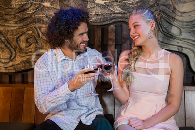 Couple toasting glass of wine in bar