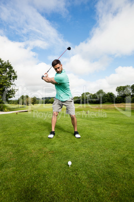 Focused man playing golf