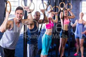 Portrait of smiling people with gymnastic rings