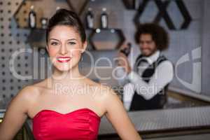 Portrait of beautiful woman standing in bar