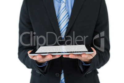 Mid section of businessman holding mobile phone