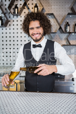 Bartender pouring beer in glass