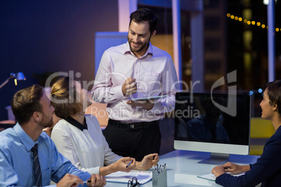 Businesspeople interacting with each other in conference room