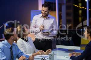 Businesspeople interacting with each other in conference room