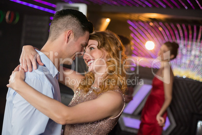 Cute couple dancing together on dance floor